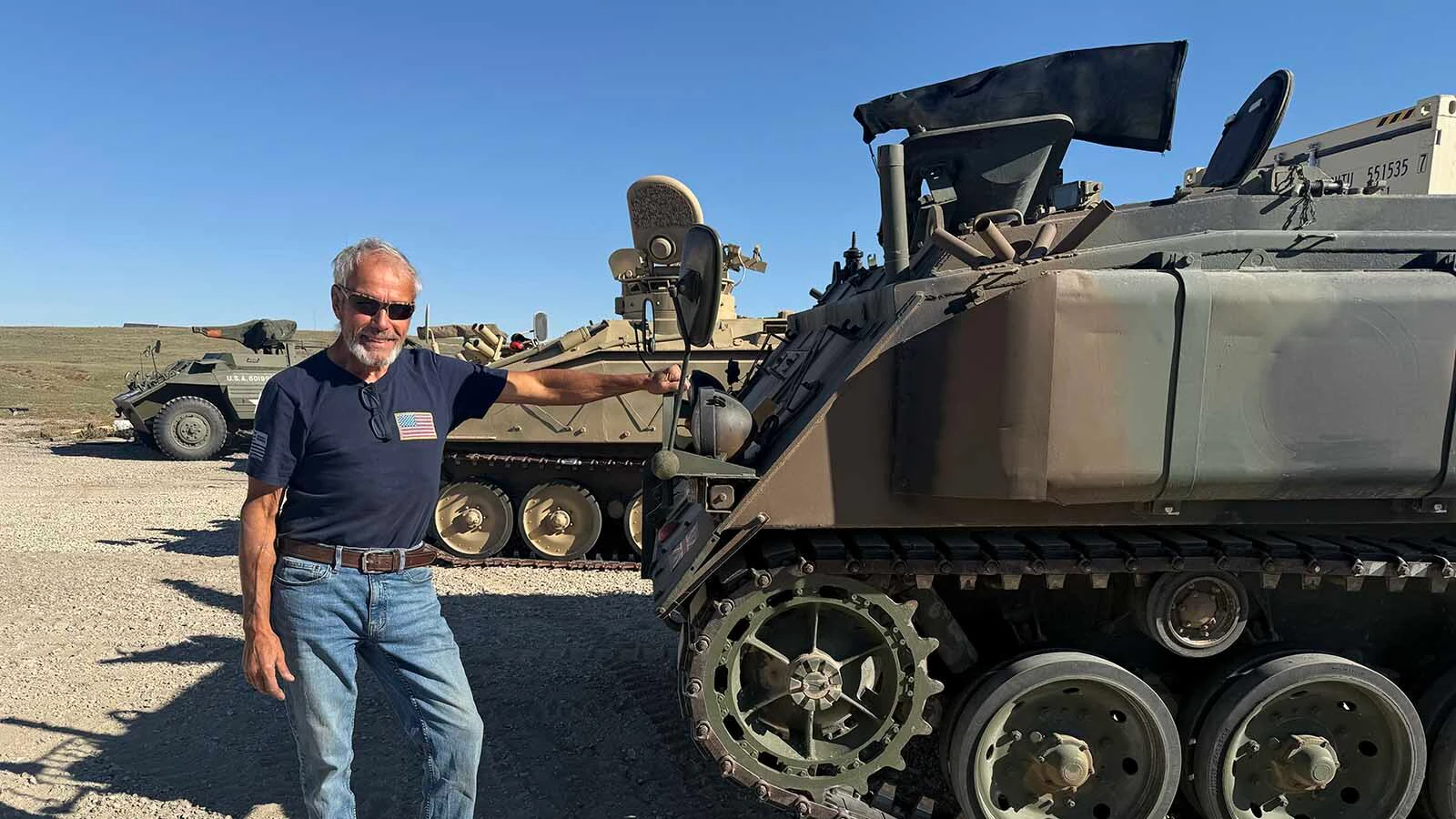 Pedro Pirado, 71, stands beside one of the tracked military vehicles in his collection near Big Sandy Lake outside Glendo. 