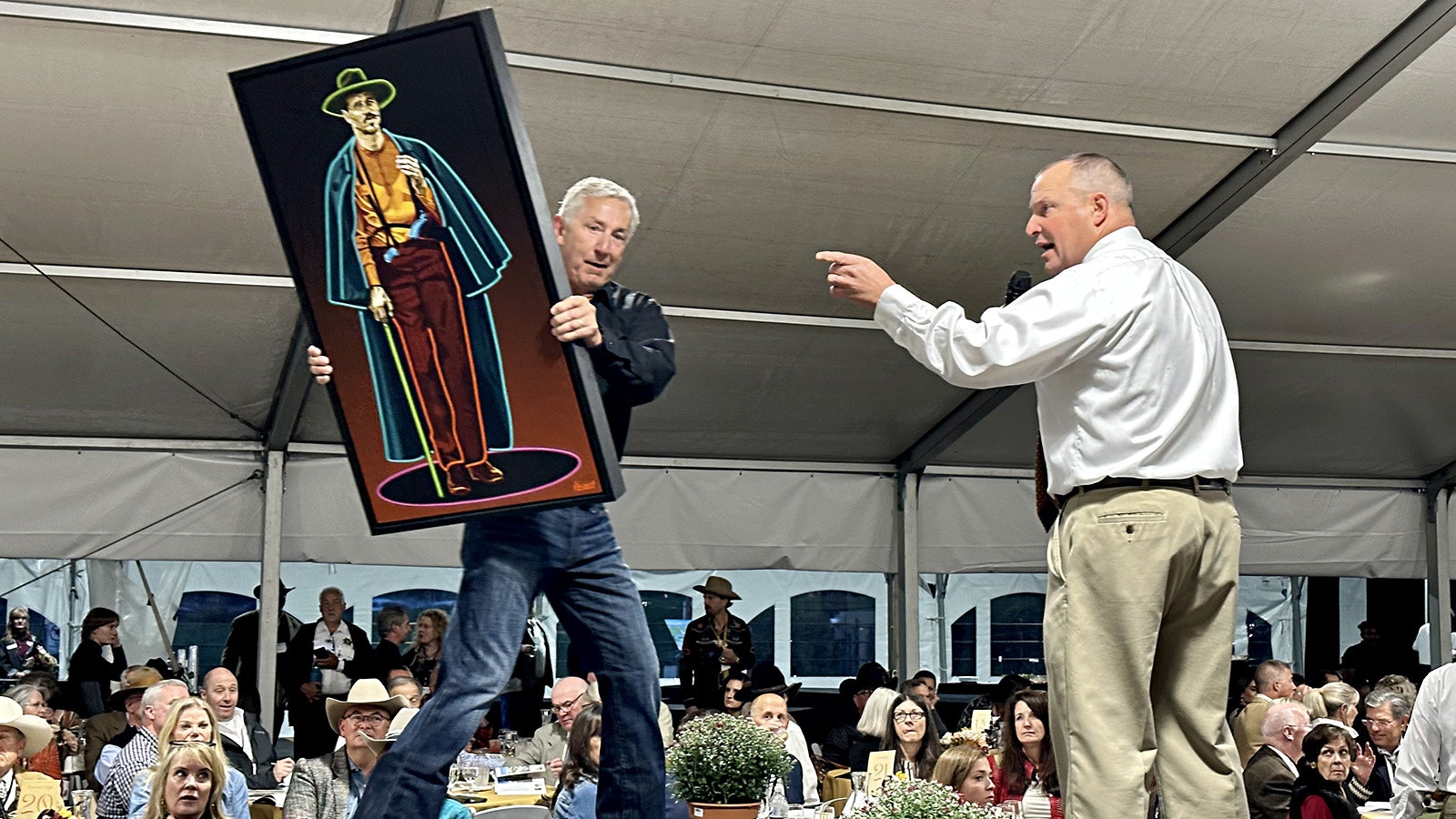 Auctioneer Troy Black auctions off the painting "You're a Daisy if You Do" by Michael Blessing during the 42nd Buffalo Bill Art Show and Sale Live Auction. The piece sold for $8,500.