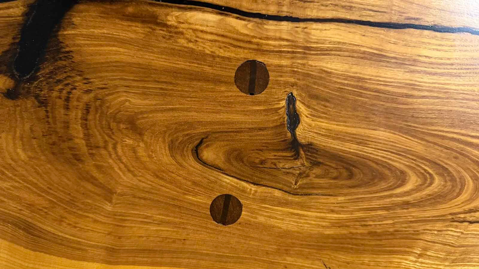 An ancient ash wood tree was mistakenly cut down in its prime at the Washakie County Courthouse in Worland in 1999. Groundskeeper Heather Shryack rescued the wood and nearly 30 years later, her husband, Terry, and visual artist Calvin "Cal" Fulfer have made the wood into a stunning 600-pound table, mixing medieval design with modern art.