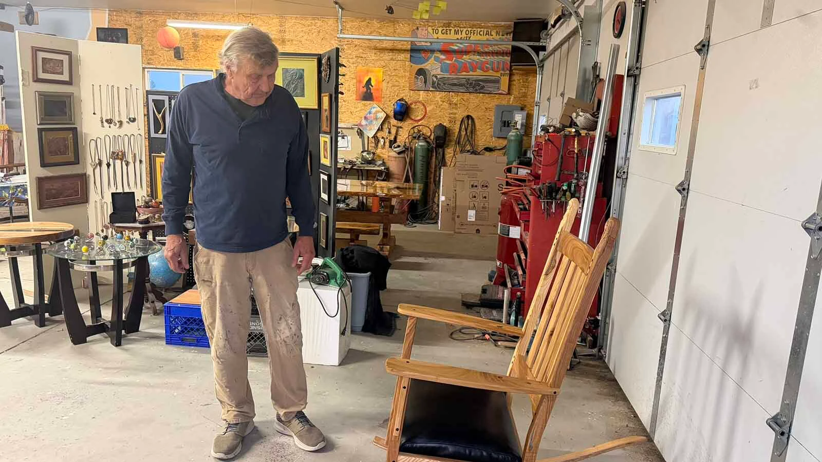 Terry Shryack is a talented wood worker that has used the wood from an old ash tree, cut down in its prime by mistake, to build a rocking chair and now, a 600 pound table in a medieval design. He is grateful to his wife, Heather, for saving the wood so that today, the memory of the ash tree lives on in his furniture.