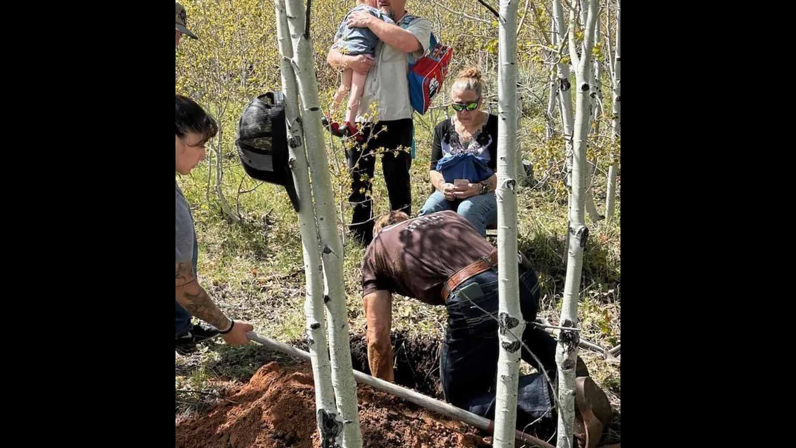 Ashley Rose Jackson's father and brothers help bury her ashes as her mother, Shannon Clark, right, looks on. Jackson's family says memorials like this have helped them begin the difficult process of grieving her loss.