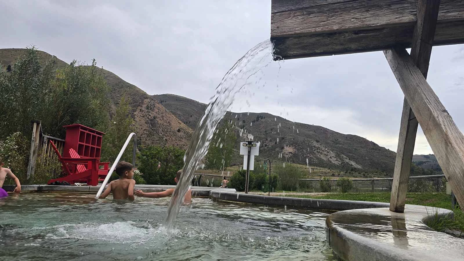 Hot mineral springs water pours into one of six hot springs pools for soaking at Astoria Hot Springs Park in Jackson Hole.