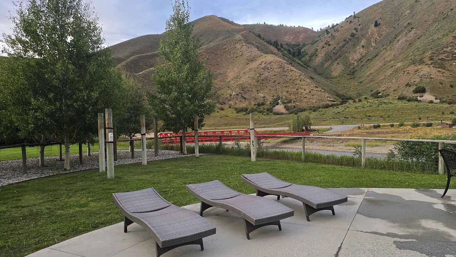 Sunbathing chaise lounges strategically positioned for the view at Astoria Hot Springs Park.