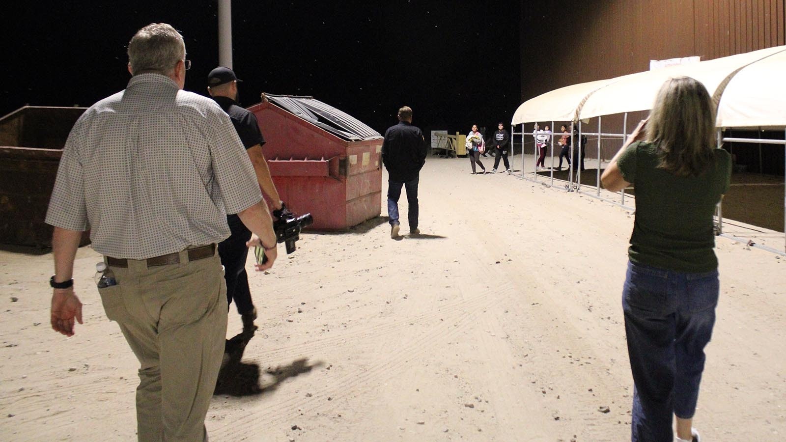 State Sen. Stacy Jones, R-Rock Springs, left, and Rep. Jon Conrad, R-Mountain View, approach a group of immigrants who had just crossed the border illegally.