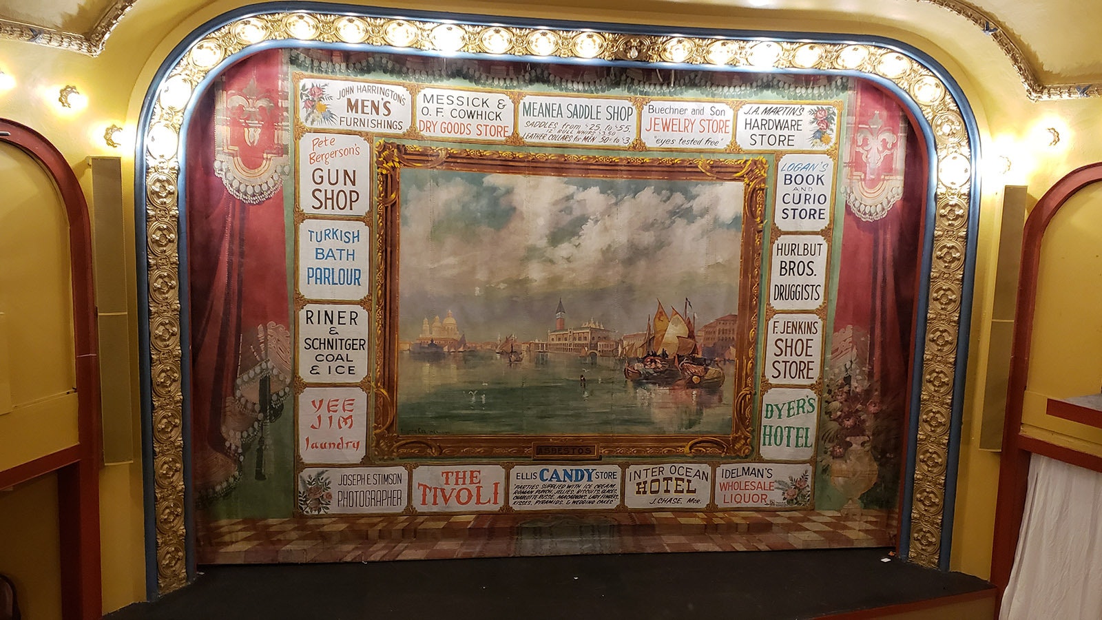 The curtain at the Atlas Theatre in Cheyenne with a Venice scene and word "ASBESTOS" prominently displayed.