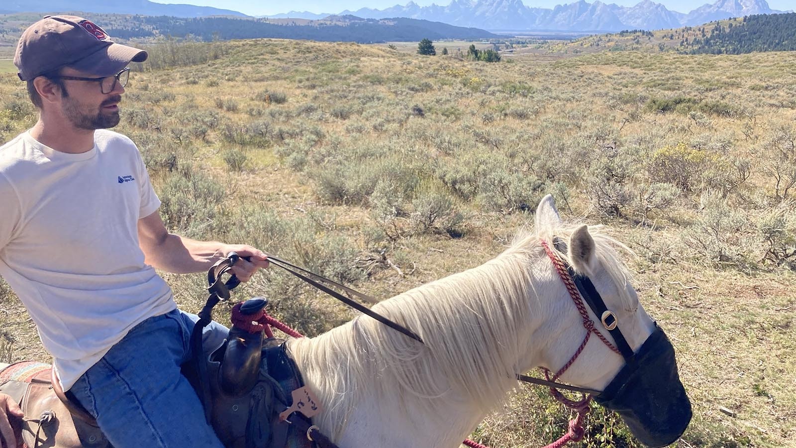 Austin Hawkins, author of “Going Nowhere Slow,” enjoys exploring Wyoming however he can which, in this case, is from horseback.