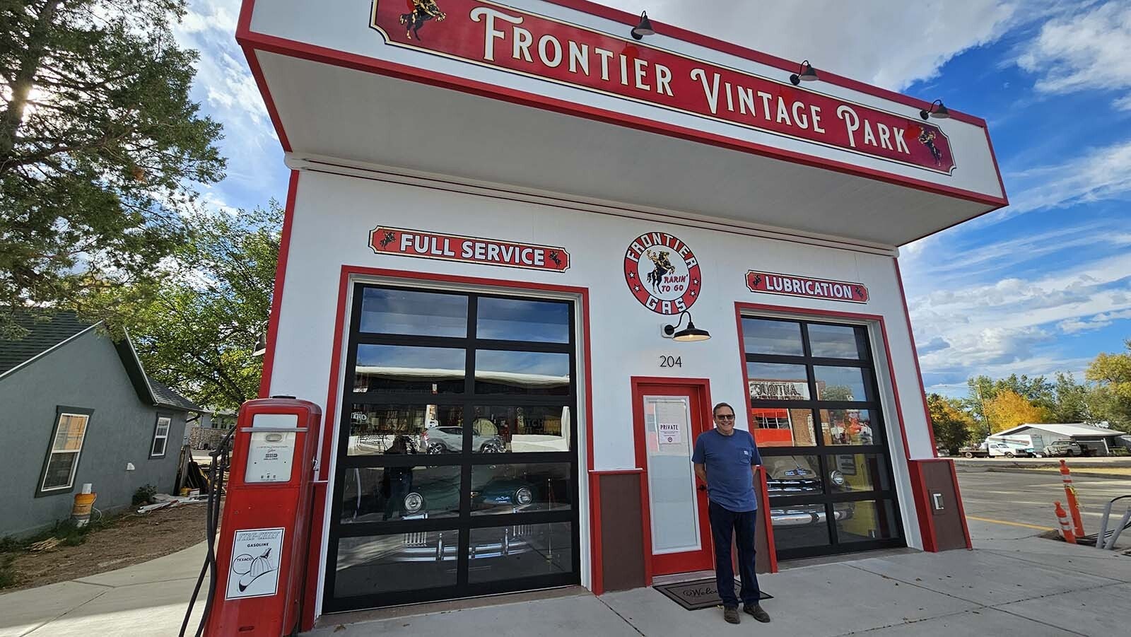 Jeff Wandler stands outside the vintage automobile-themed Airbnb recently completed, right across from the Frontier Auto Museum that Wandler owns. The Airbnb features not one by two vintage cars, along with lots of vintage car memorabilia and signs.