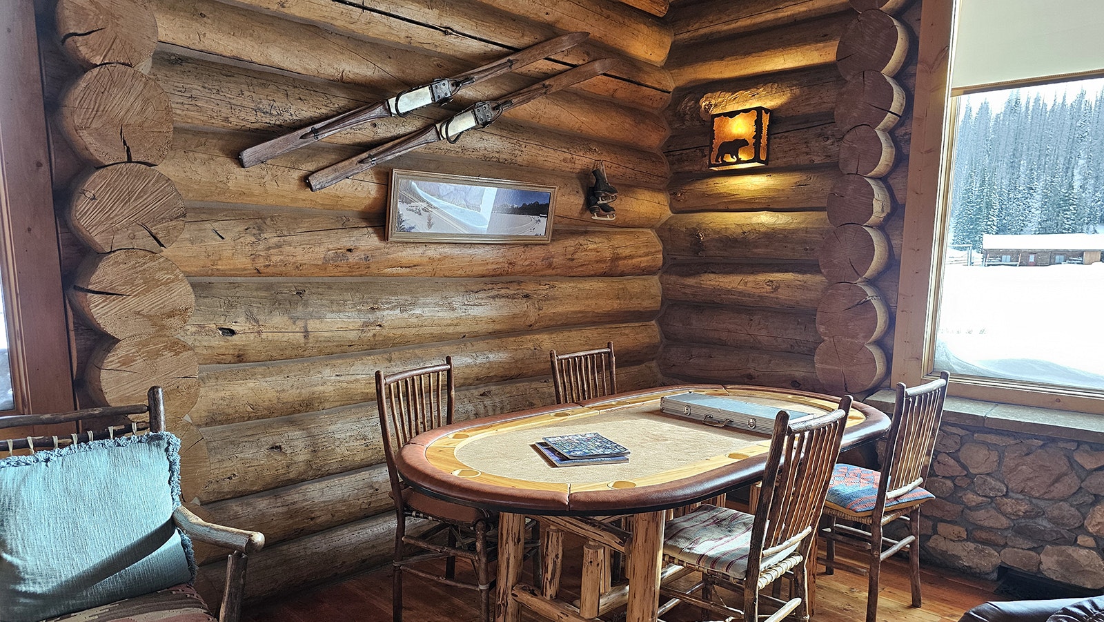 Artifacts from winters gone by as well as artwork adorn the rustic hewn log cabin walls.