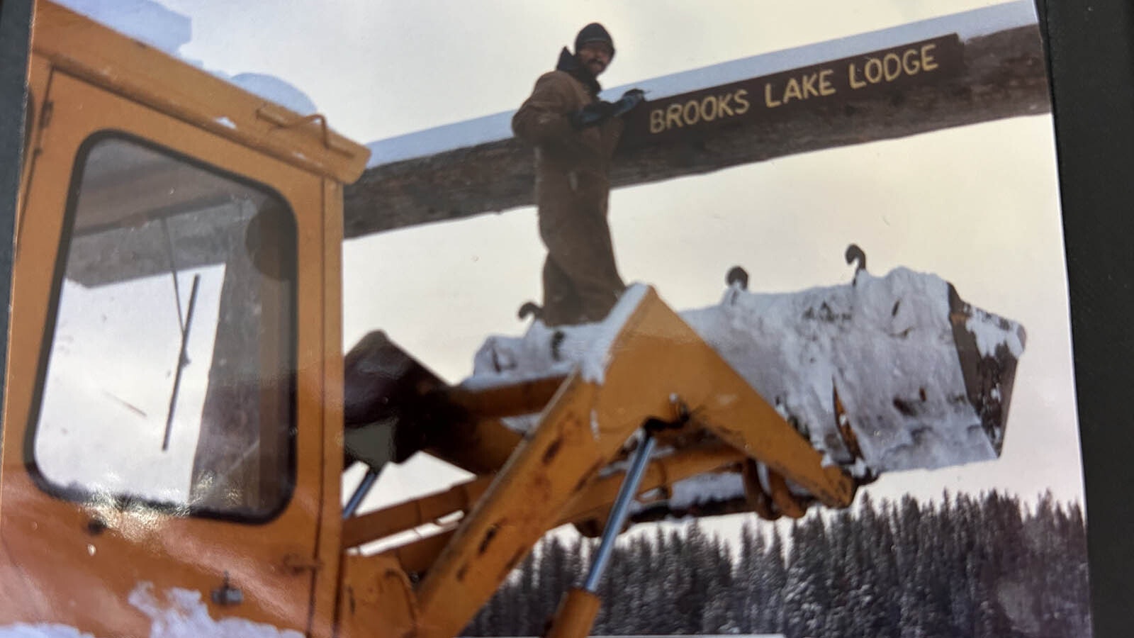 Putting up the Brooks Lake Lodge sign the opening of the 1988 season.