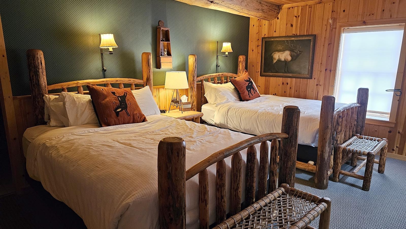 Rooms at Brooks Lake Lodge are cozy with feather beds for sleeping and rustic benches for putting on one's shoes.