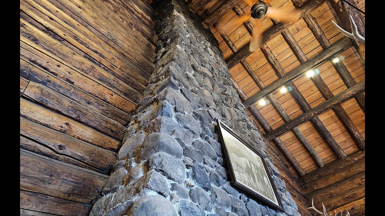 Scorched rock can be seen at the top of the fireplace in the dining hall's adjoining tearoom, where the lodge caught fire in 2019.