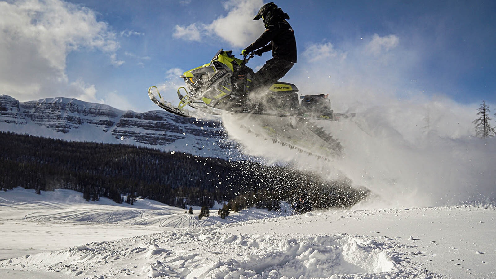 The pristine Wyoming landscape makes for a winter playground at Brooks Lake Lodge with world-class snowmobiling.