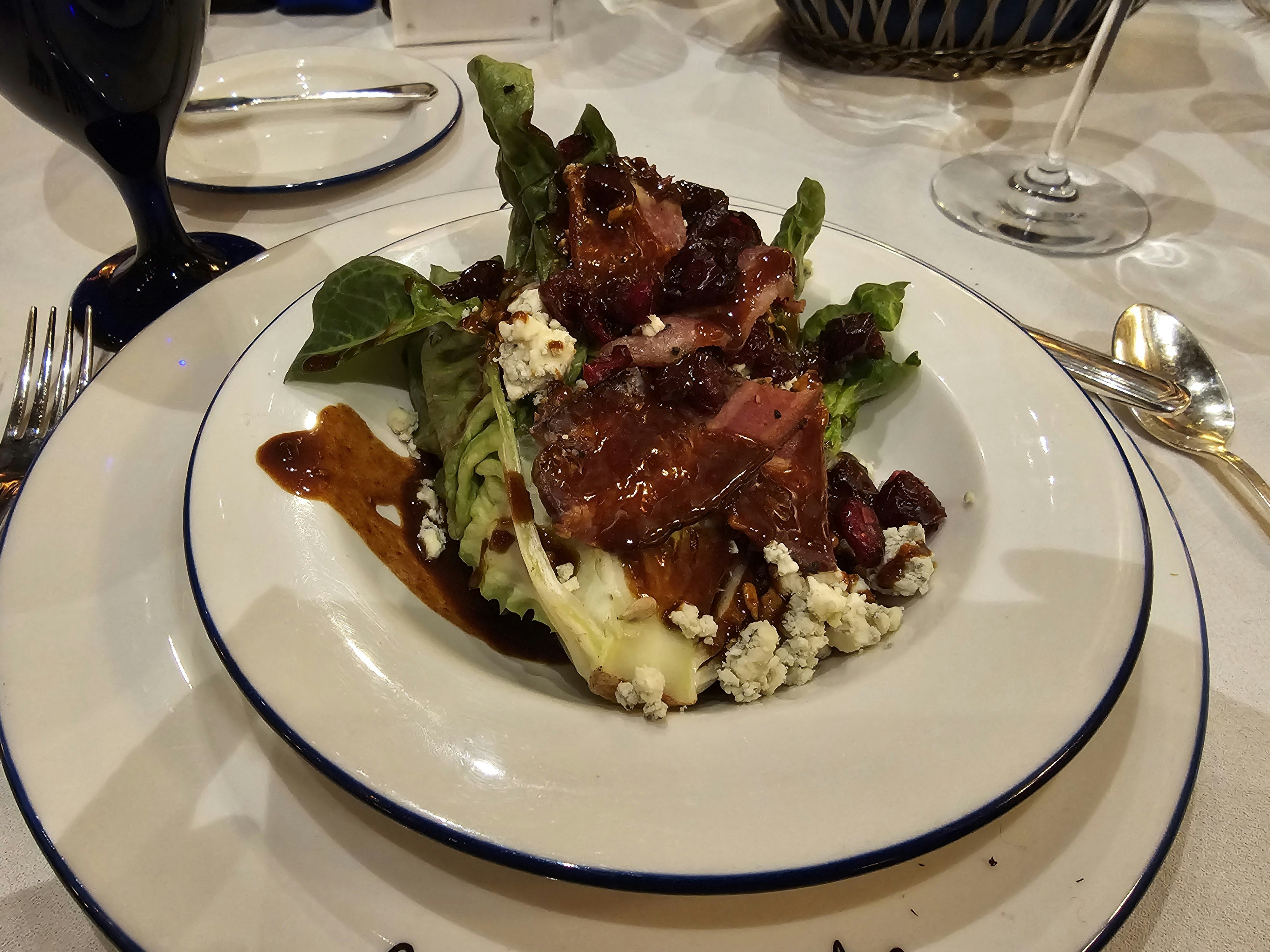 A fresh green salad with blue cheese crumbles, bacon and balsamic vinaigrette.