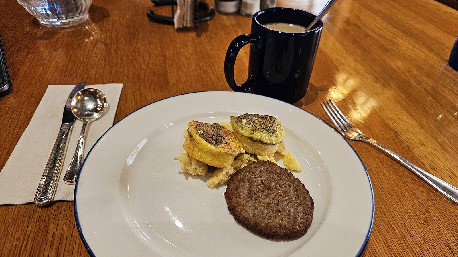 Breakfast buffet has all kinds of choices. Here, deviled egg soufflé with scrambled eggs sausage and coffee.