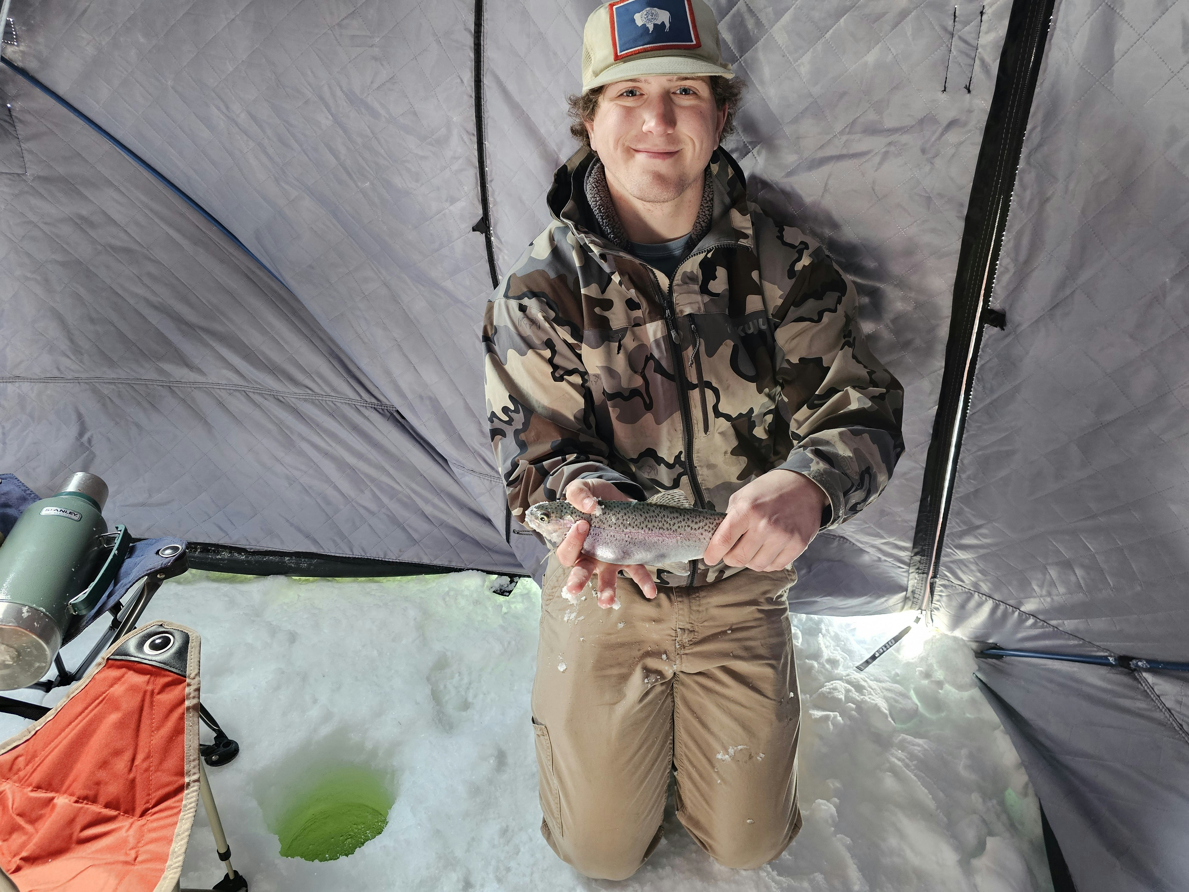 The trout that didn't get away held by ice fishing guide Isaac Jones from Mississippi. If you catch 'em, the chef at Brooks Lake Lodge will cook 'em.