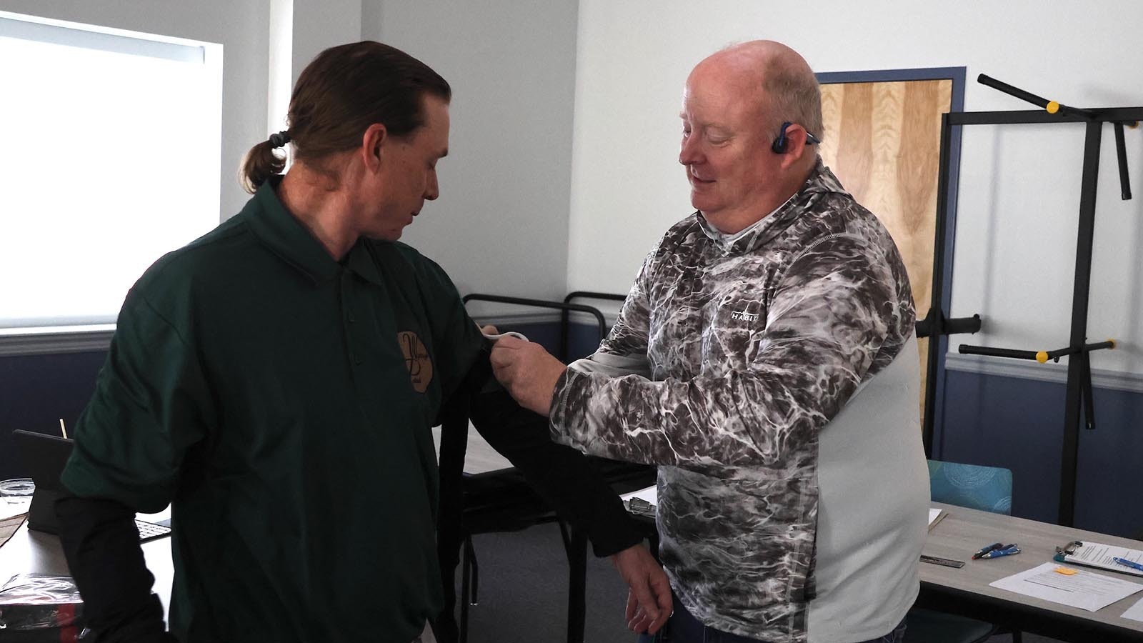 Class participant Greg Flesvig, of Evansville, right, practices applying a tourniquet to Eric Paulson, president of the Wyoming Patriots. Paulson said the group, which sponsored the class, has a mission to help prepare people in the state for everyday emergencies.