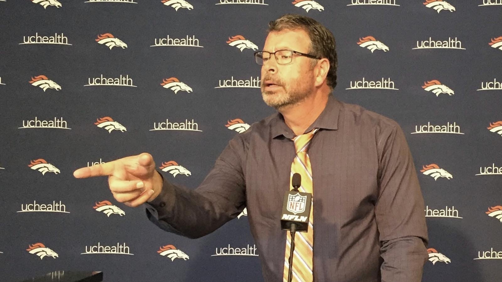 Former Denver radio host, and Wyoming native, John Baggett stands at the podium of a Denver Broncos press room.