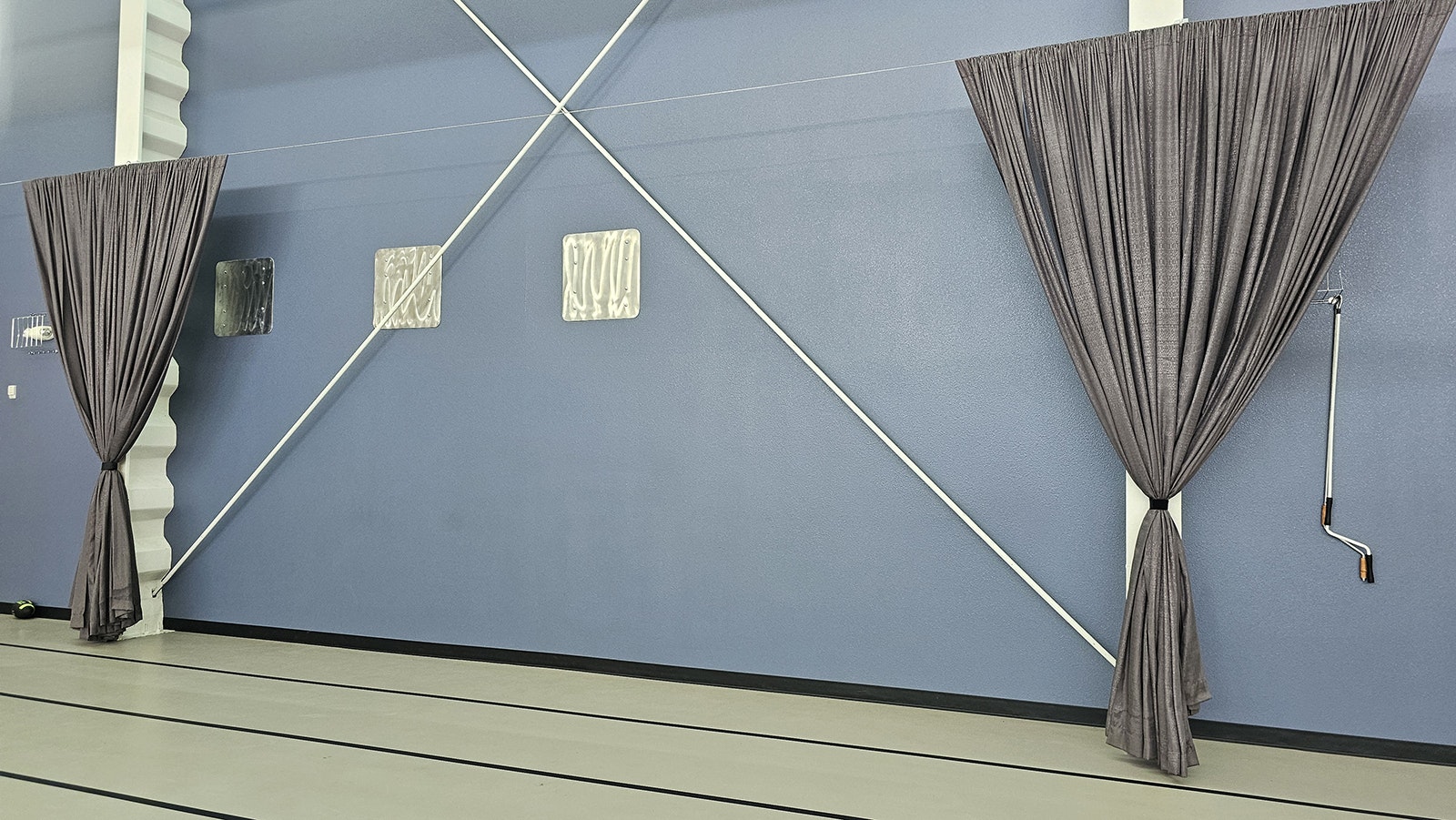 These curtains can be spread across the entire gymnasium floor for special occasions, creating an event center instead of a basketball court and workout space.