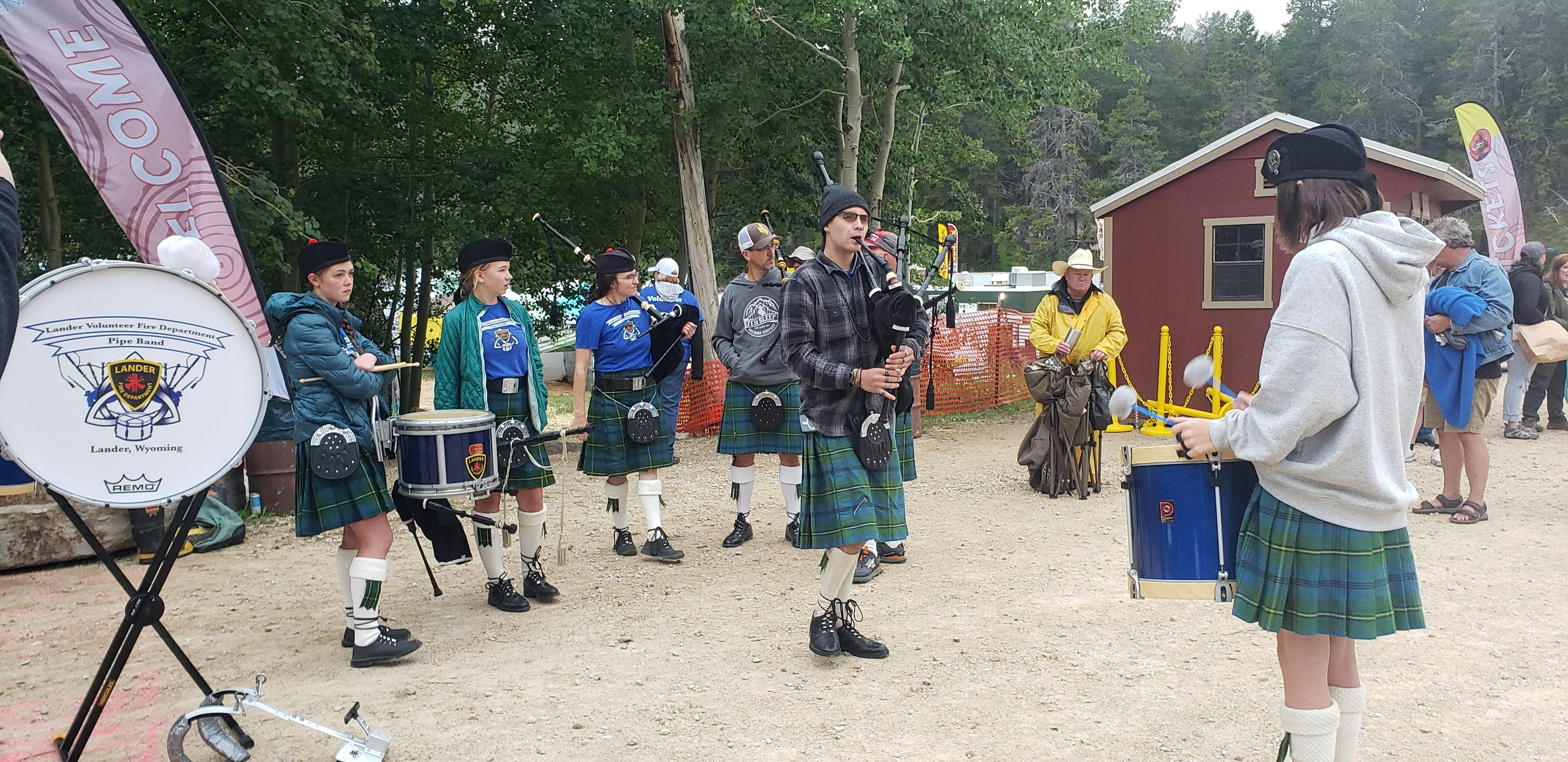 Other members of the Lander Pipe Band listen and tap their toes along with the rhythm.