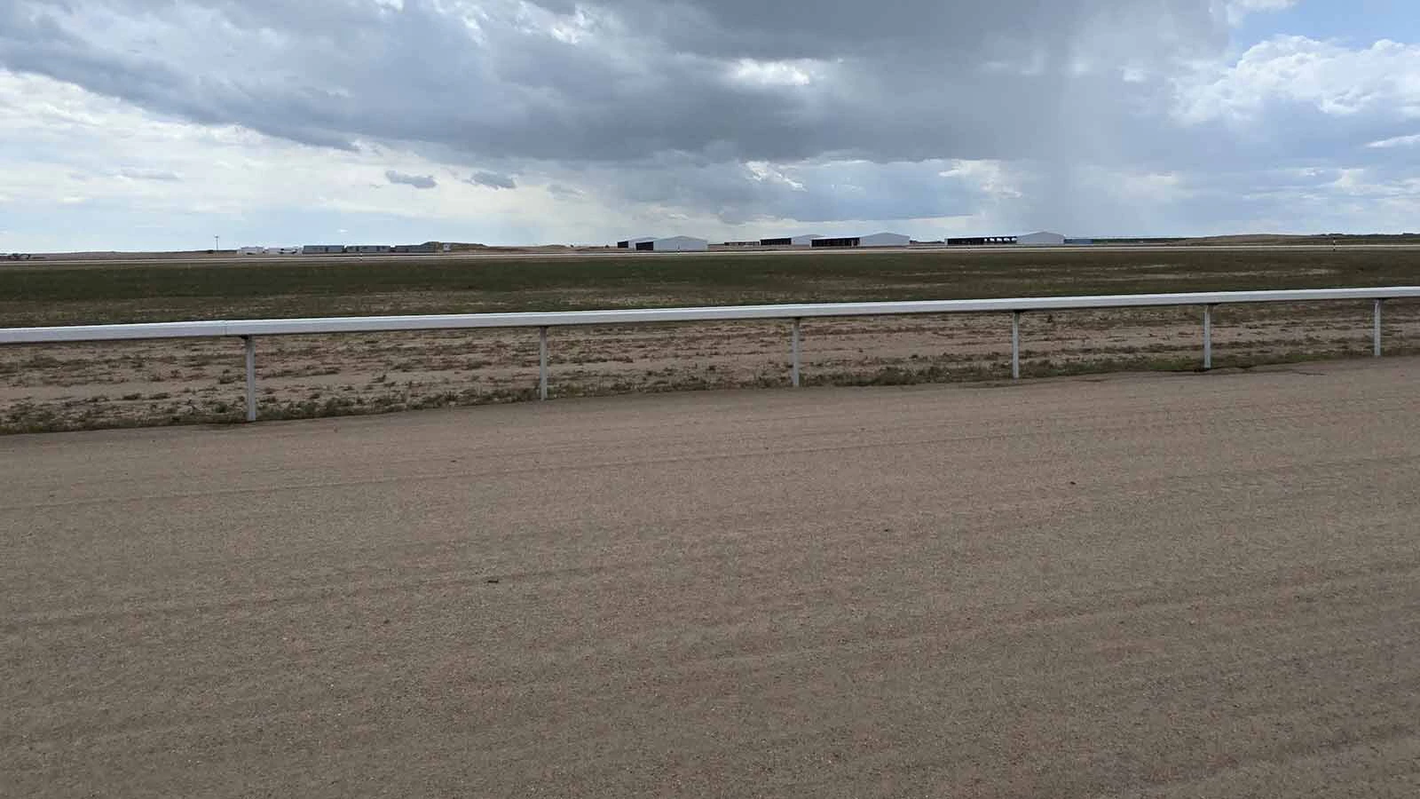 Rain clouds were collecting overhead, and fat raindrops were landing on what will be Wyoming’s first 1-mile racetrack.
