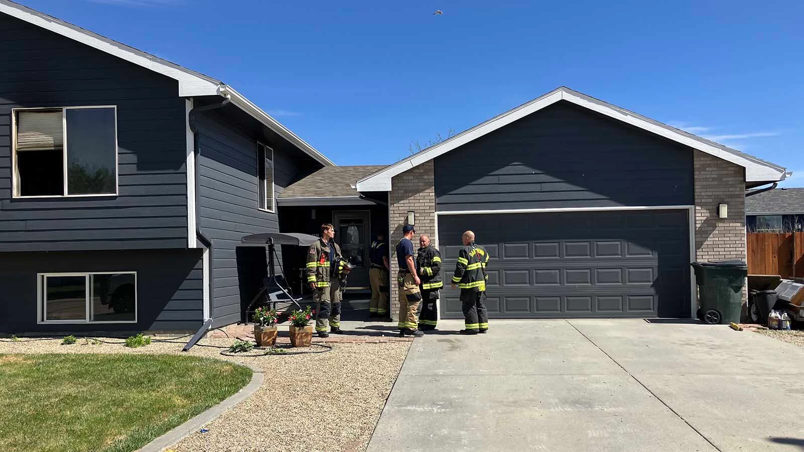 Firefighters check the Bar Nunn home on Friday morning for any hot spots.