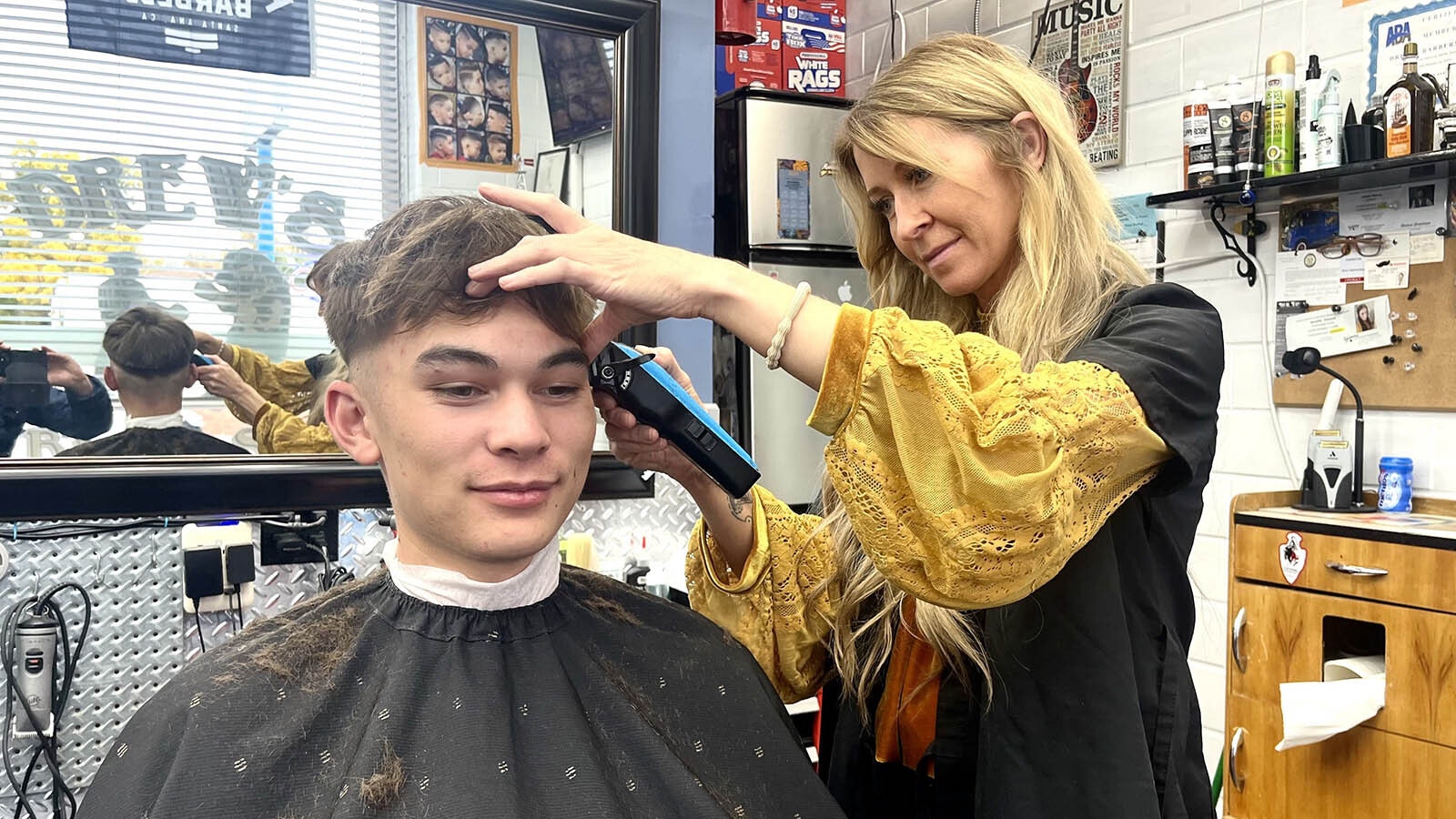 Barber Jen Vincent, right, cuts Reese Kopka’s hair at Drew’s Barbershop on Friday afternoon.