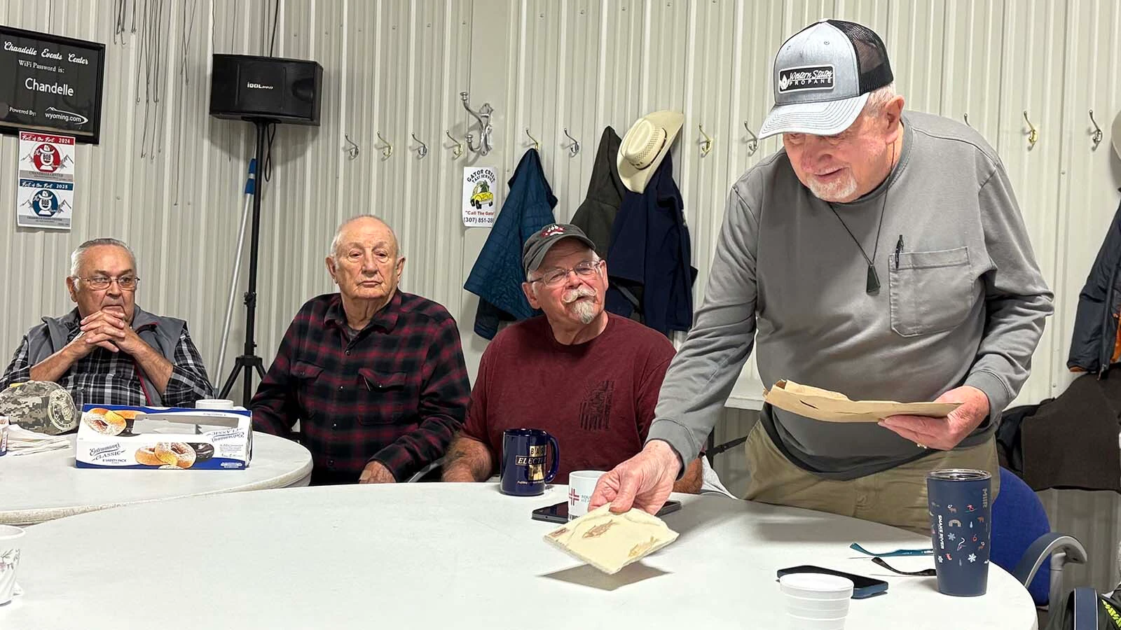 Lonnie Woodard, one of the Riverton “Gentry” coffee klatch members, presented gubernatorial candidate Eric Barlow with the state fossil, and a bit of jade as a gift after Barlow fielded questions from the group Monday