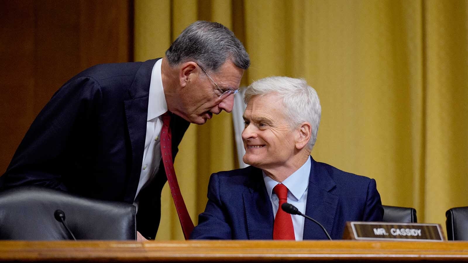 Sen. Bill Cassidy, R-Louisiana, right, speaks with Sen. John Barrasso, R-Wyoming, as Health and Human Services Secretary Robert Kennedy Jr. appears before a Senate Finance Committee hearing at the Dirksen Senate Office Building on Sept. 4, 2025, in Washington, DC.