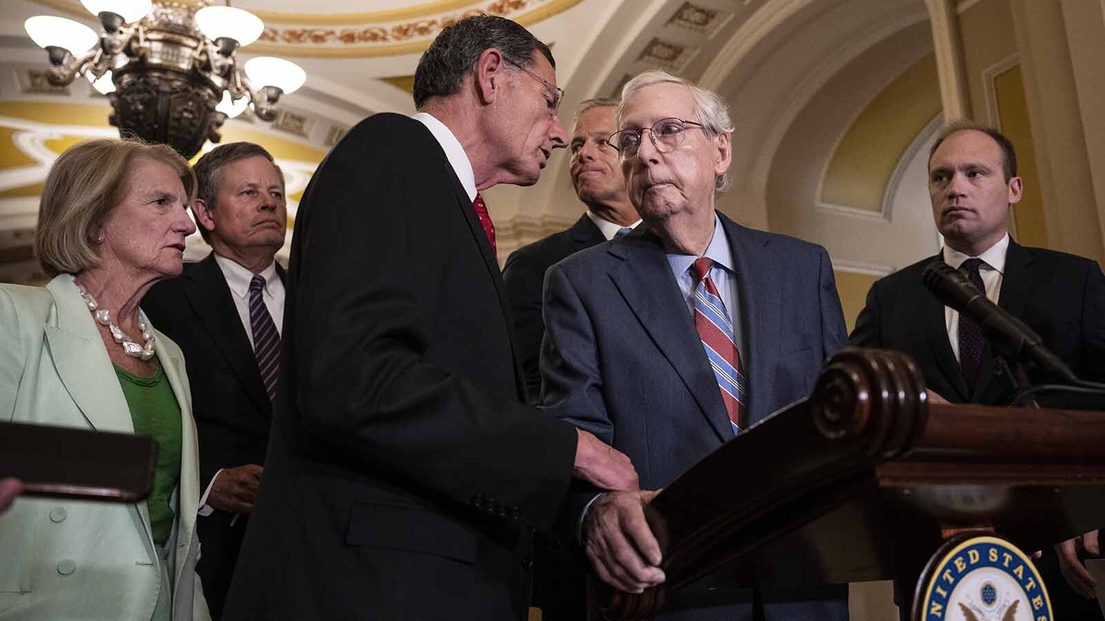 Wyoming U.S. Sen. John Barrasso, left, helps U.S. Senate Minority Leader Mitch McConnell in July after McConnell suddenly froze up during a press conference. After another episode Wednesday, there's talk about who would succeed McConnell. As the No. 3 Republican in the Senate, Barrasso is near the top of the list.