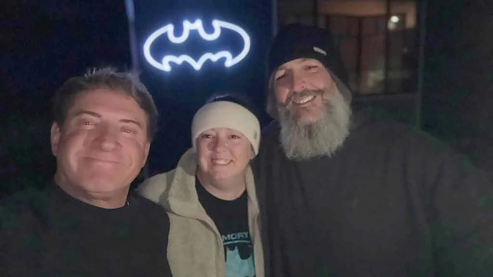 Kendell Call, left, and Emily and Justin Sweitzer with the Bat-Signal.