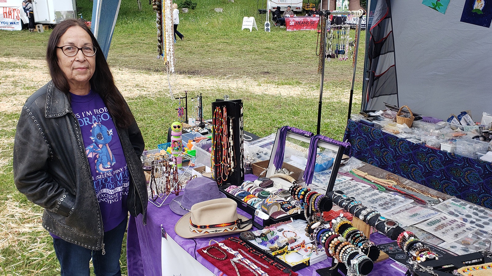 Sheryl McLaughlin poses with a table full of her beadwork and jewelry. She's been a mainstay vendor at the Beartrap Summer Festival for 25 of its 30-year run.