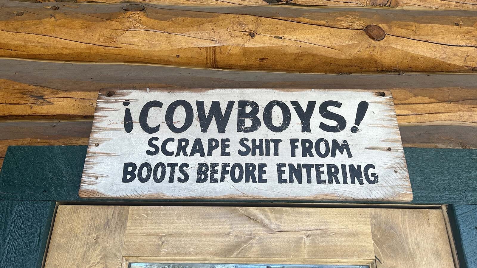 A sign at the Daniel Junction Foodmart reminds cowboys to scrape their boots.
