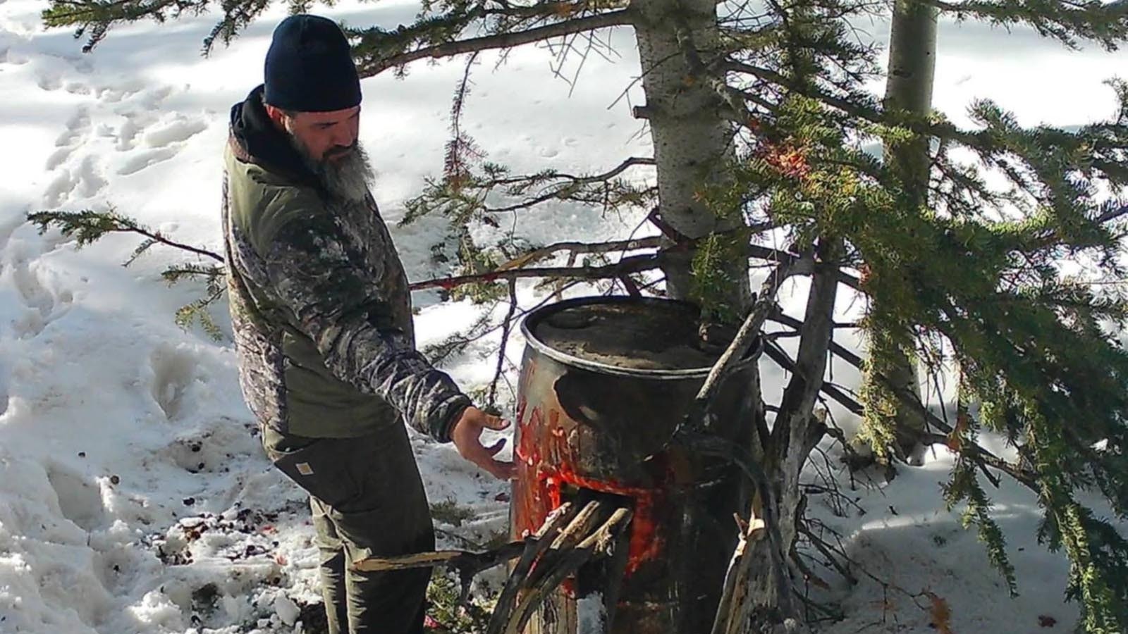 Owen Miller sets up his bear bait barrels in spring 2023. He expects there to be much less snow at his hunt site this spring.