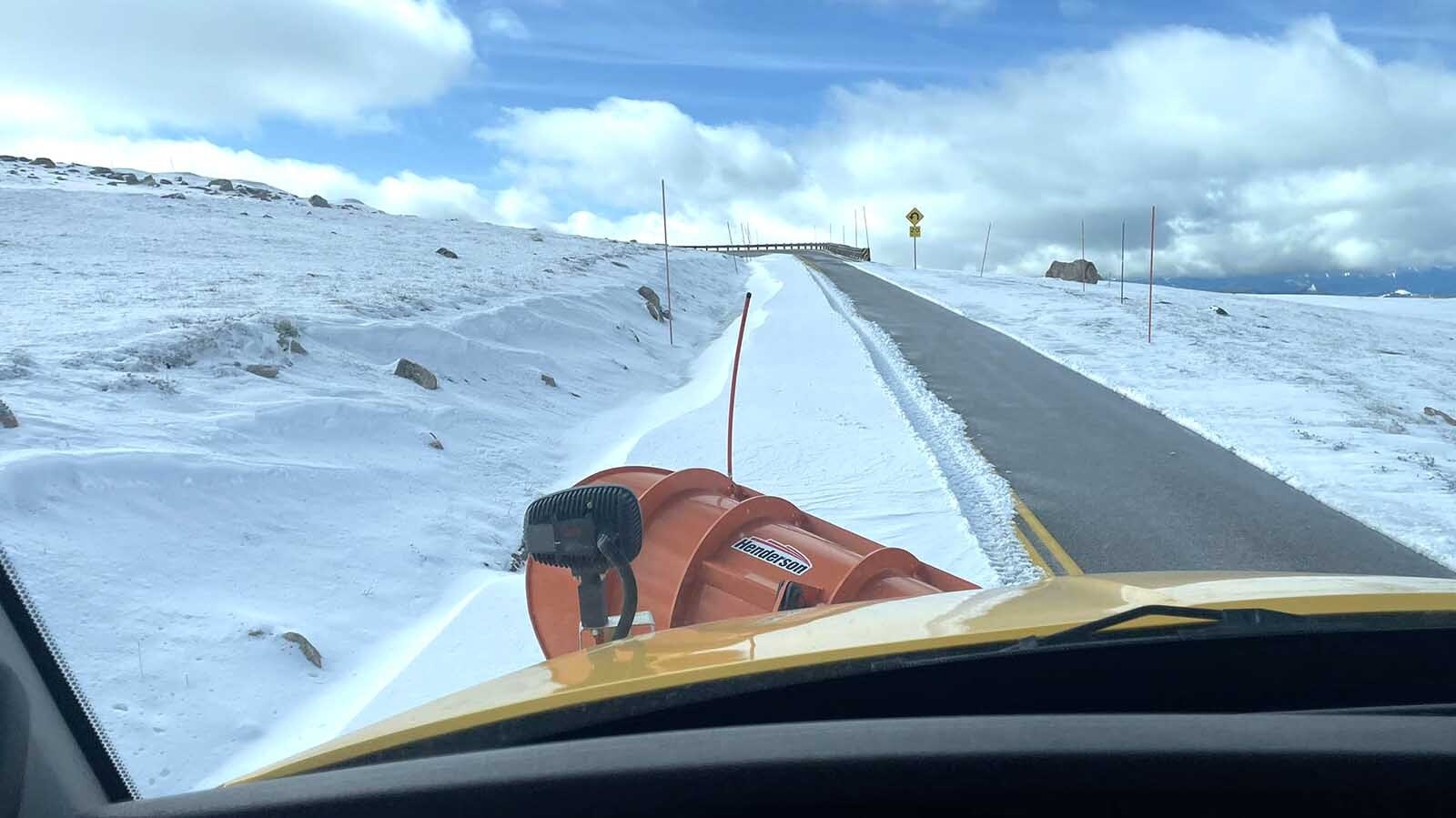 The Wyoming Department of Transportation is working Monday to clear 3-foot snowdrifts off the Beartooth Highway after a blast of mid-June winter blew through Wyoming over the weekend. Other parts of the state saw record-low temperatures.