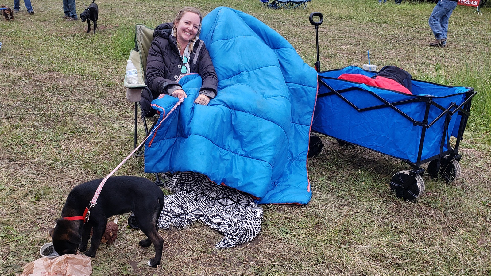 Christy Johnston and pet Zoey under a sleeping bag. Her boyfriend, Anthony Palato, is hiding underneath the sleeping bag because at the time it was cold enough to see one's breath.