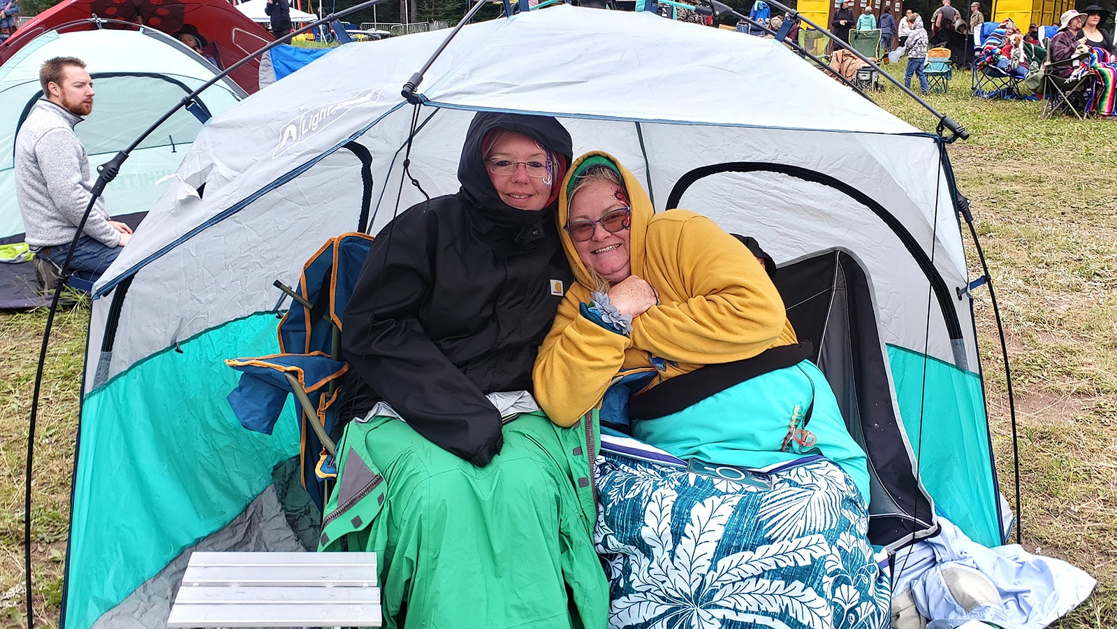 Kelly Buckley and Robbie Literas huddle under sweatshirts and blankets with a popup tent. They were enjoying themselves in spite of the chilly weather Saturday evening.