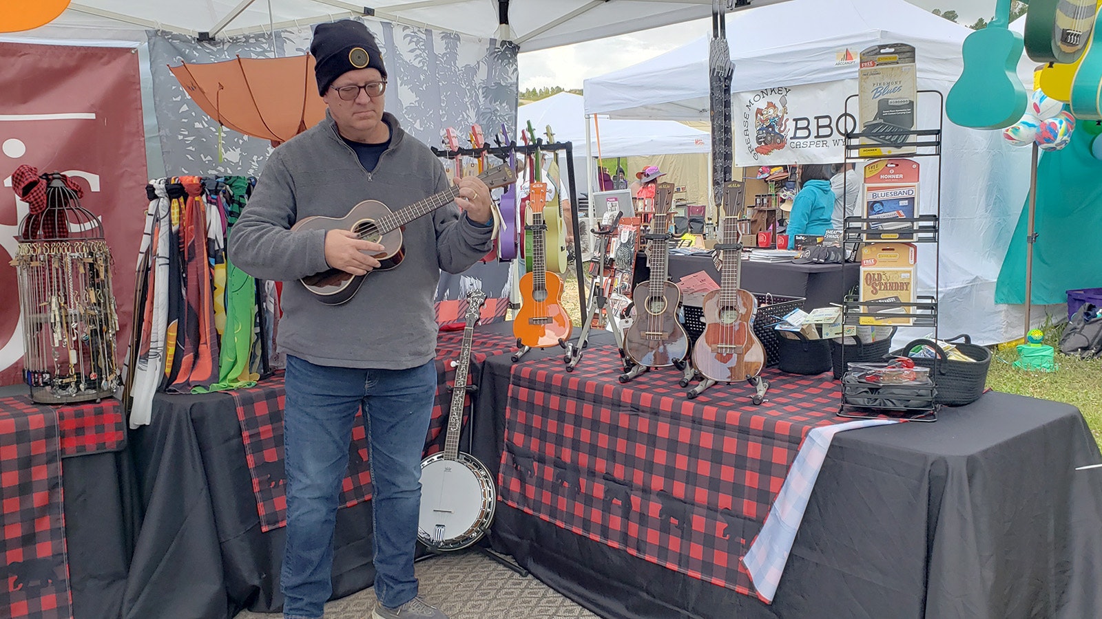Kurt Gilbert holds a ukulele at the Hill Music store booth at Beartrap Summer Festival in Casper.