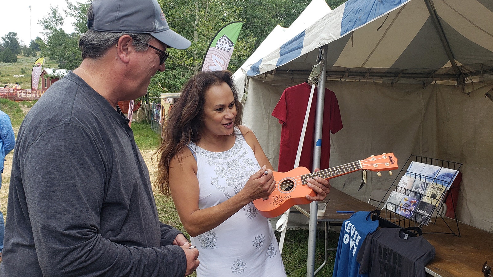 Wendy Woo signs a ukulele for Kurt Gilbert, who owns Hill music in Casper.