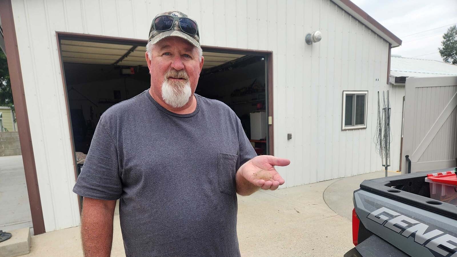 Pete Herman displays a tuft of fur from the bear that attacked his hives.