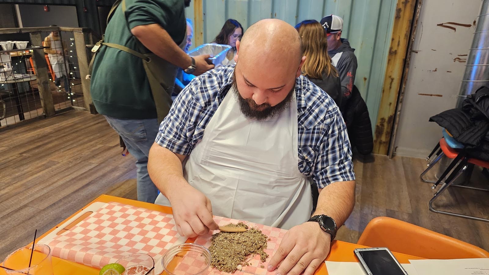 Eli Vurgess spreads mushroom duxelles on his prosciutto.