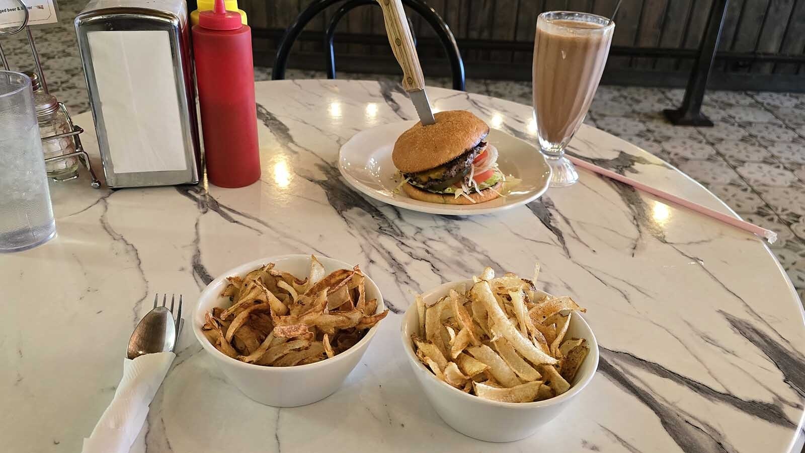 The taste test arrives. One bowl are tallow fries, and one vegetable oil fries. A chocolate malt is on standby for the taste test, as well as a ranch-raised, grass-fed burger from the Chugwater Soda Fountain.