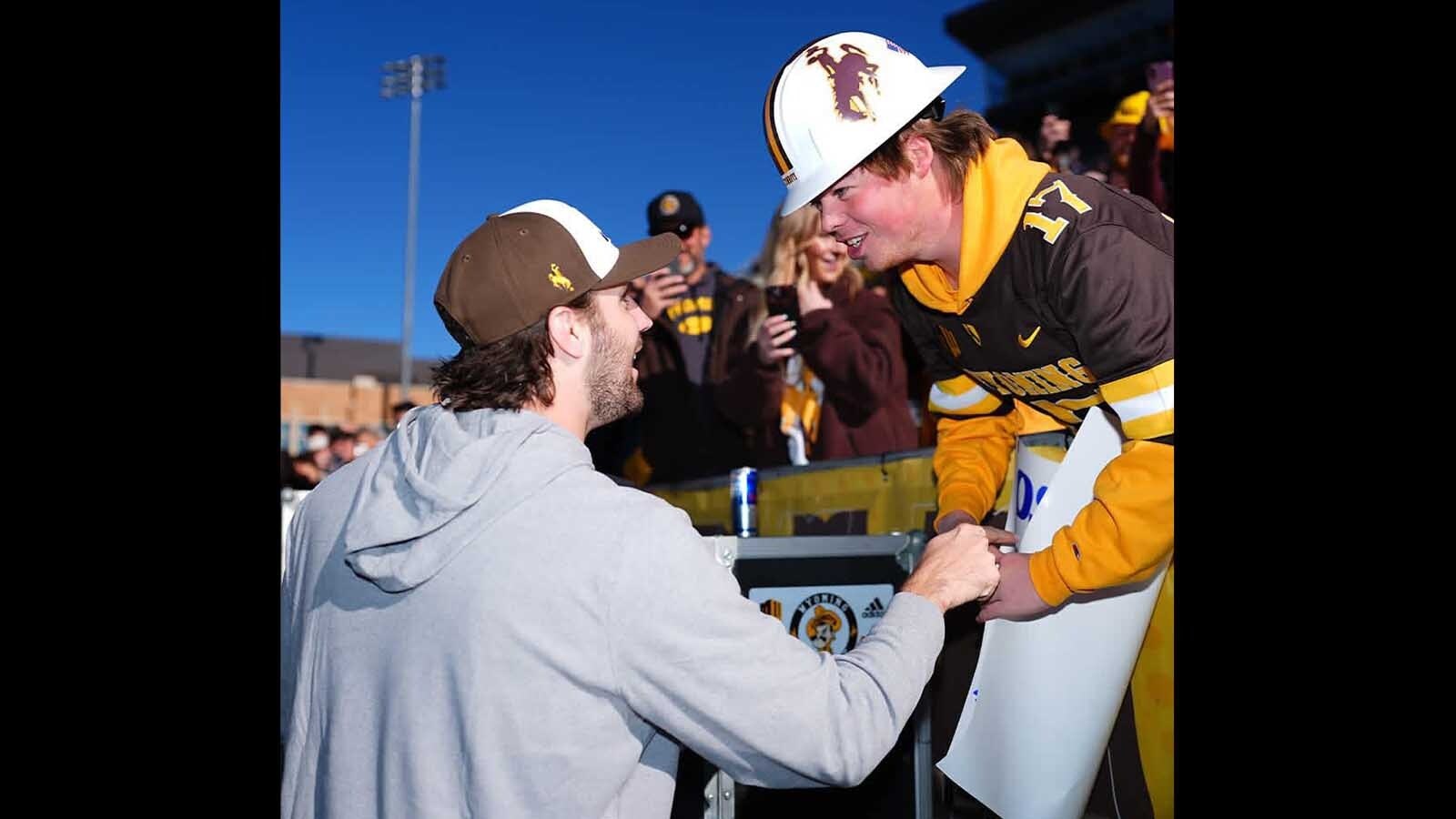 Josh Allen, left, called Jaxon Sweep’s number and challenged him to start a giant beer snake at War Memorial Stadium.
