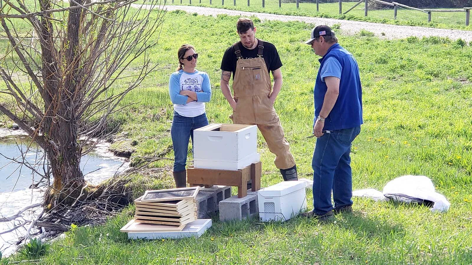 Along the banks of a spring-fed pond near Etna, beekeeper Mike Morrison leads an open apiary workshop on installing honeybee colonies.