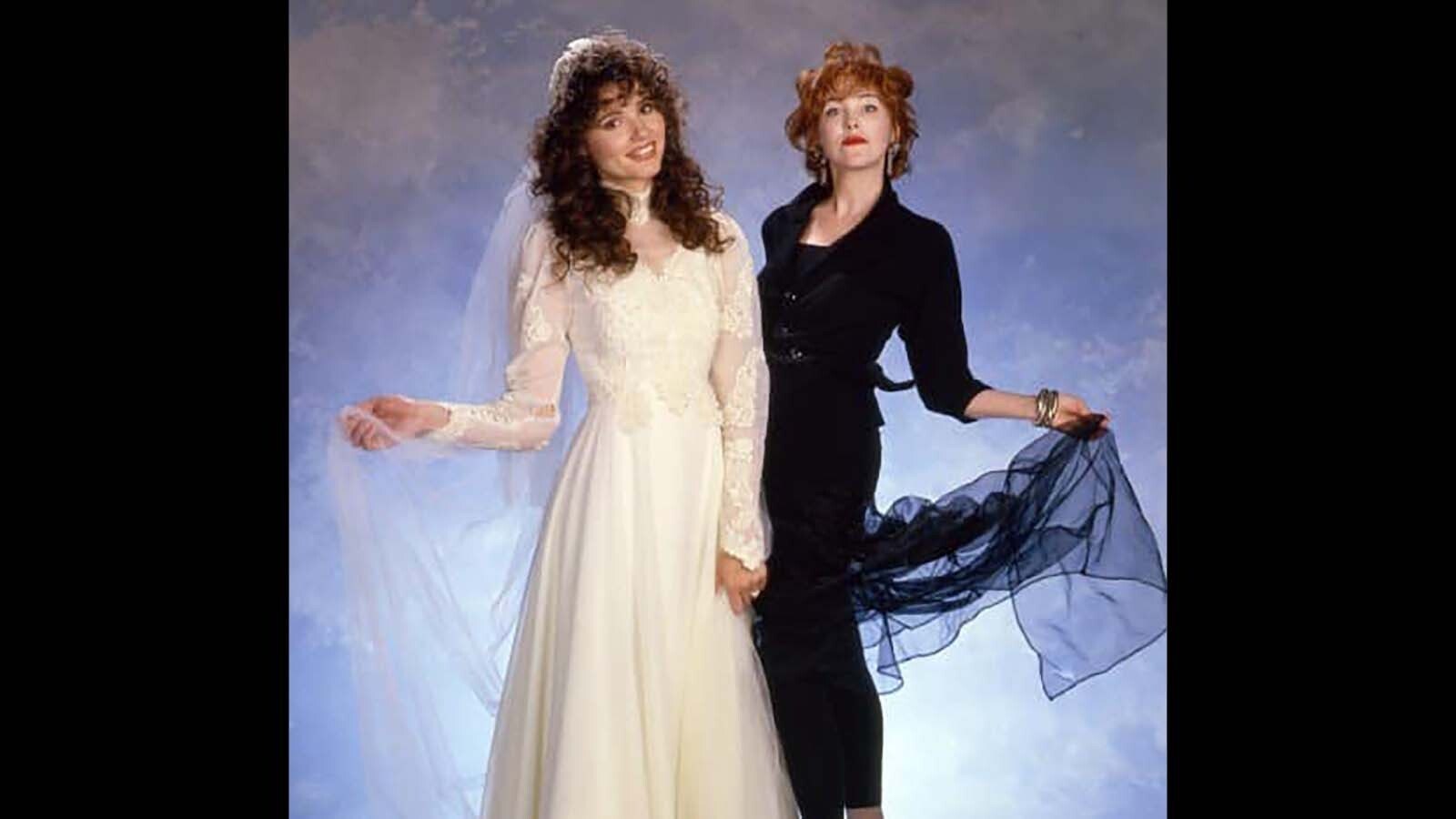 Geena Davis, left, in the white wedding dress she wore in the original 1988 film "Beetlejuice." She's pictured here with Catherine O'Hara, who played the annoying stepmother.