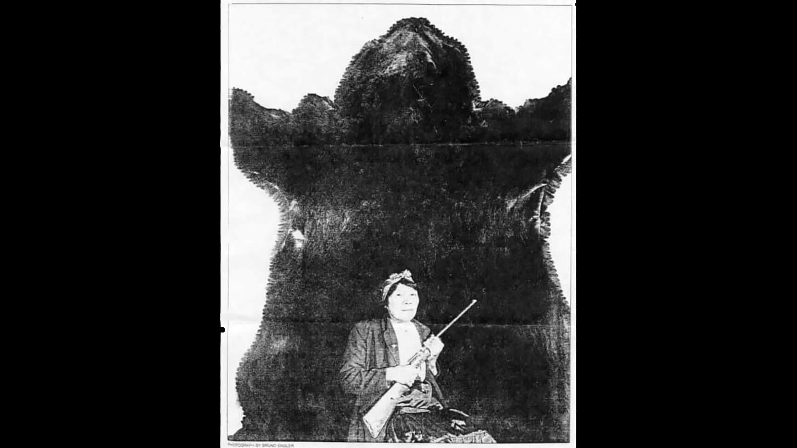 Canadian Cree Bella Twin, 63 at the time, poses with the hide of huge grizzly bear and the single-shot .22 rifle she used to kill the bear in 1953.