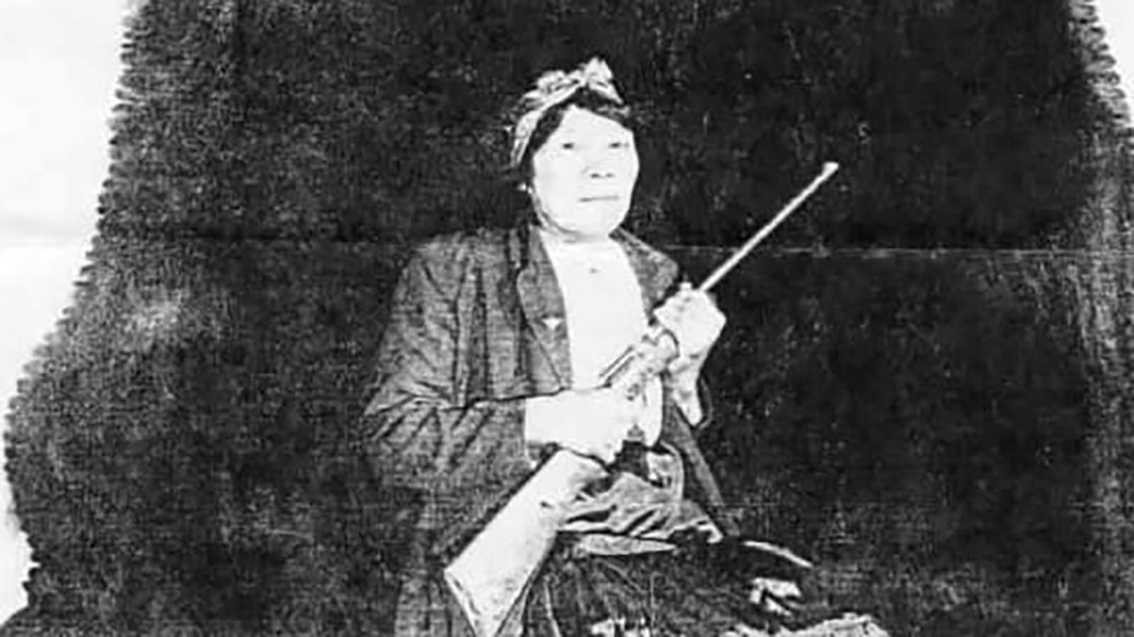 Canadian Cree Bella Twin, 63 at the time, poses with the hide of huge grizzly bear and the single-shot .22 rifle she used to kill the bear in 1953.