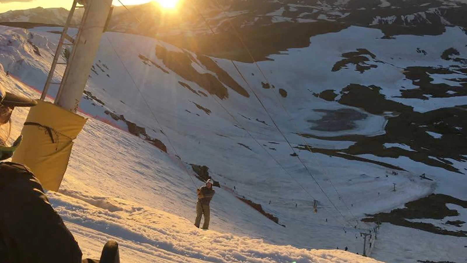 A snowboarder rides the upper Poma lift at Beartooth Basin.
