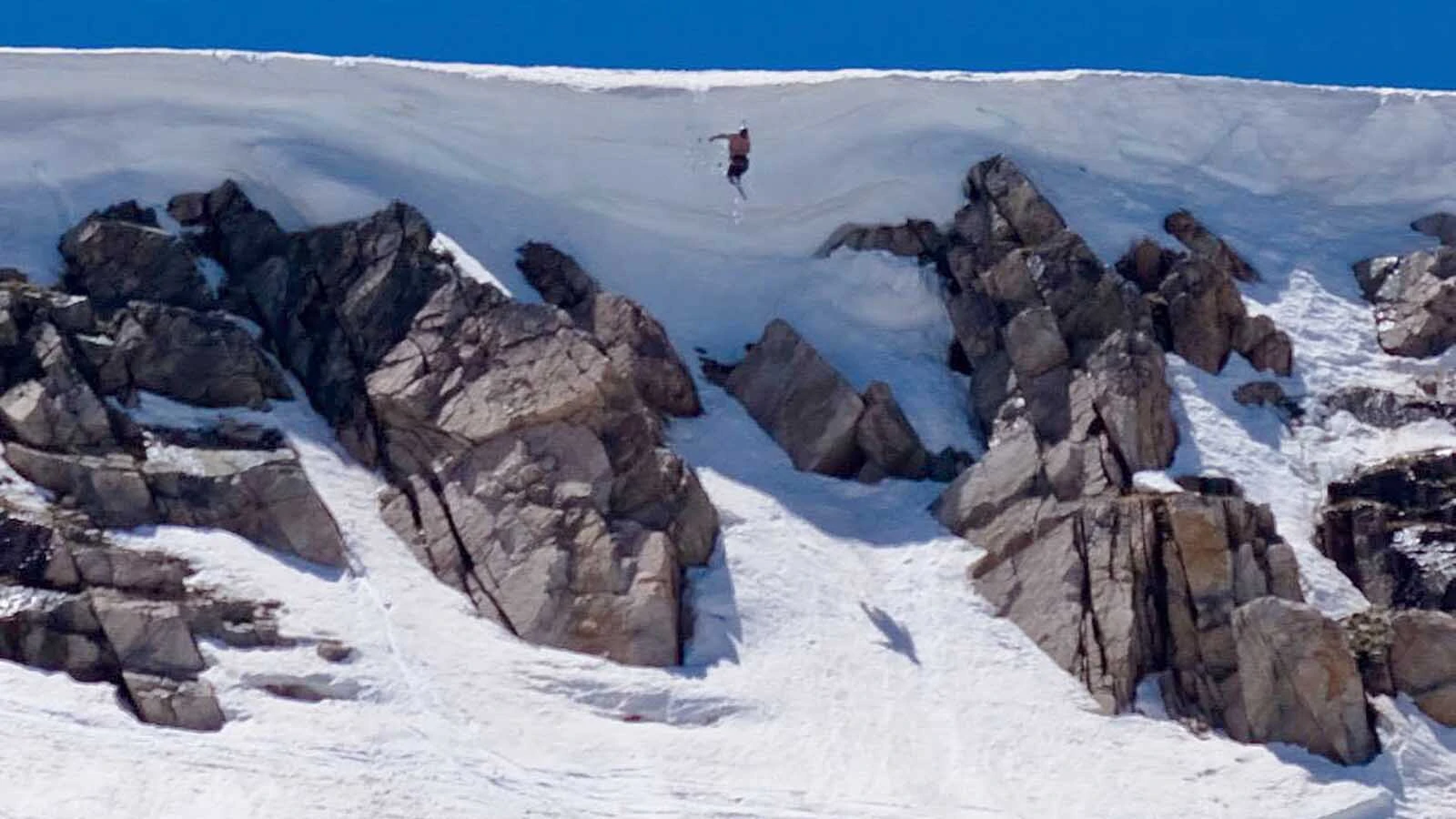 A skier drops off the top cornice in 2017.