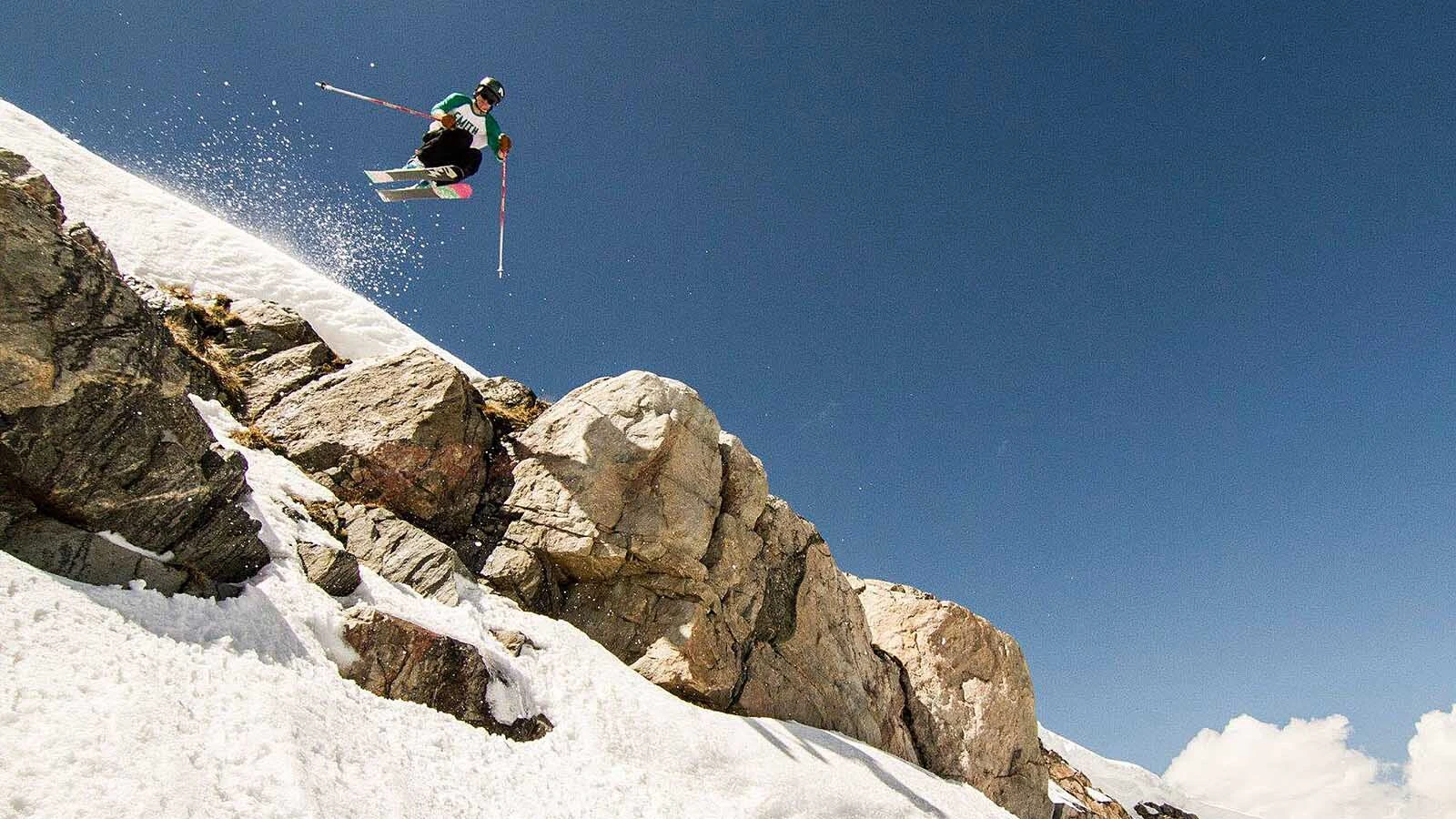 A skier hits one of the many natural features at Beartooth Basin.