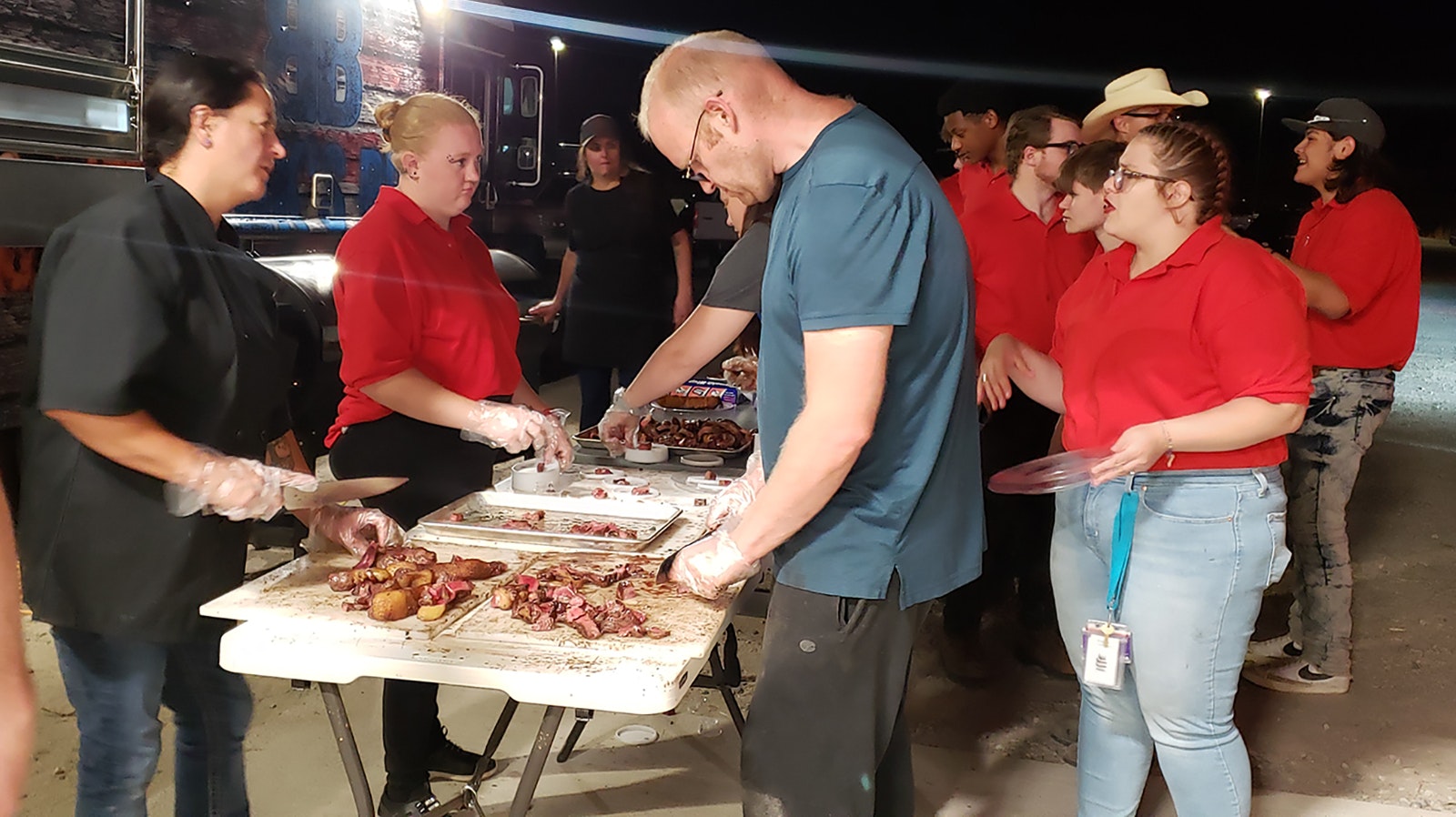 A small army of volunteers help cut up each numbered steak to serve to guests for the beef judging portion of the event.